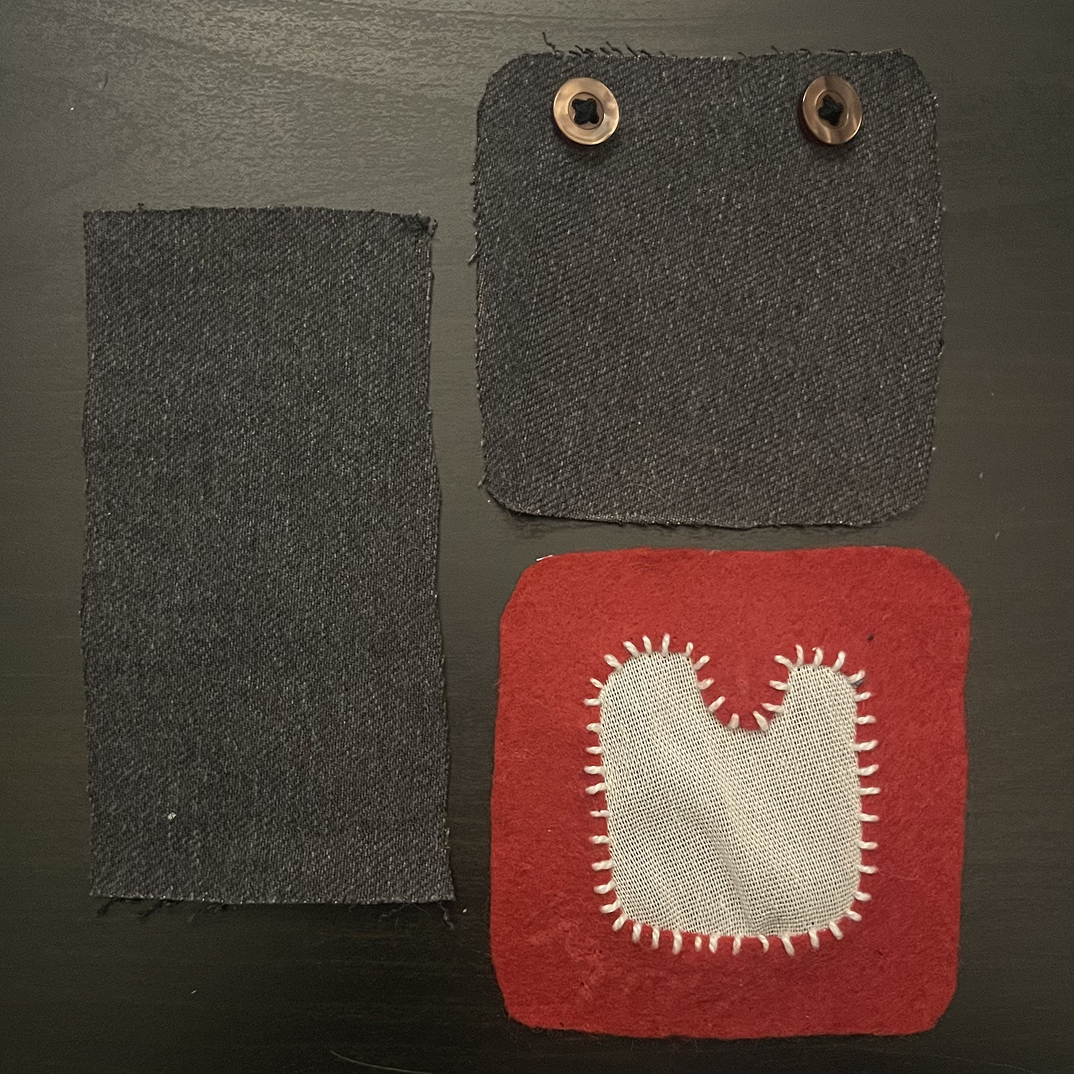 These are the three main parts of the patch. The backing with two buttons for fastening. The front for the sensor, and the band to keep it on Miffy's arm.